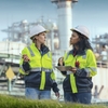 Des experts en initiatives de développement durable devant une centrale électrique