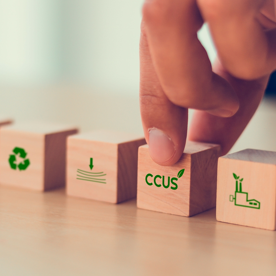 Carbon Capture, Utilization and Storage (CCUS) concept symbolized by five wooden blocks.